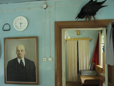 Leninporträtt och skrattande korp i datja.